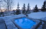 Private outdoor hot tub with mountain views.